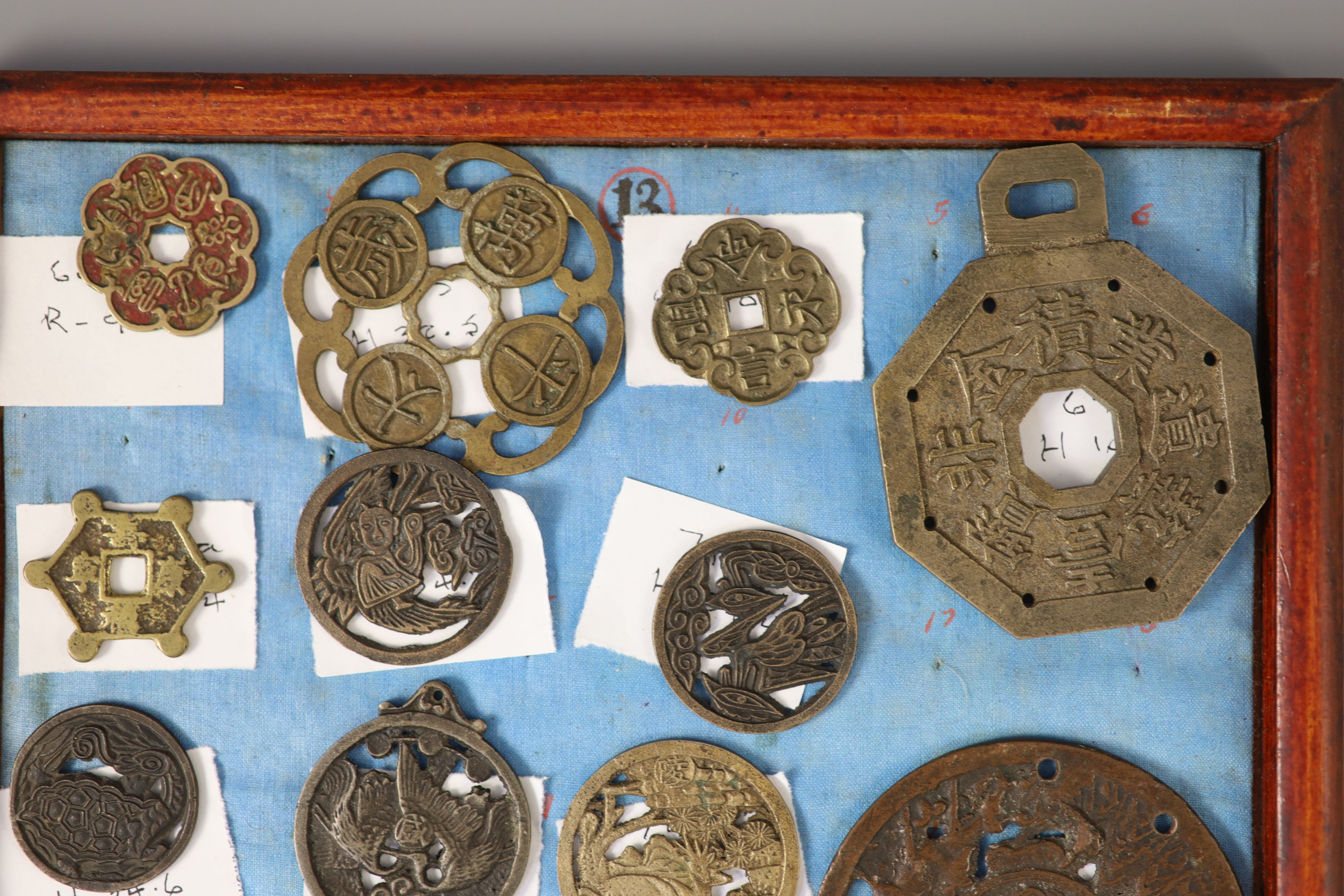 A group of 99 Korean bronze and metal amulets or charms, 19th/20th century